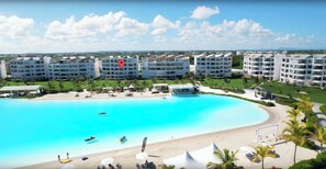 A resort with a large pool, multiple hotel buildings, and a beach area. - The Beach View, Pool Loungers, Downtown Punta Cana (Punta Cana)