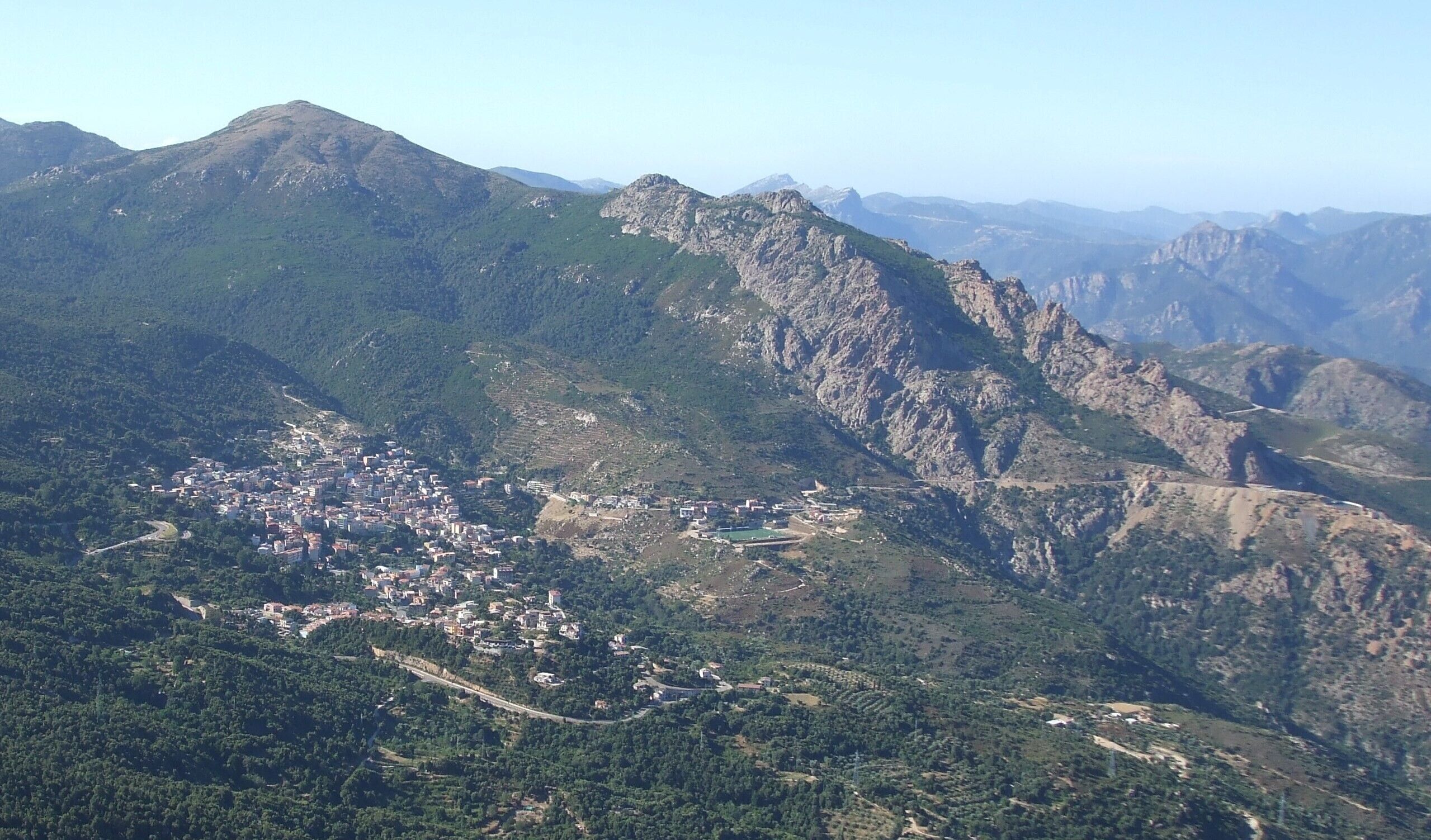 A mountainous landscape with a town nestled in the valley.