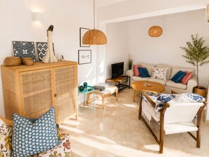 A living room with a sofa, coffee table, and a cabinet.