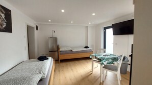 Una camera da letto piccola e luminosa, con un letto, una scrivania e una sedia.