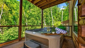 A hot tub on a wooden deck with a view of a forest. - Ultimate Mountain Getaway Pickleball & Basketball Courts Games Hot Tub Sleeps 20 (Sevierville)