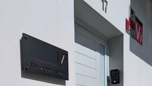 A building entrance with a light blue door, a black mailbox, and a number 17 sign. - Self-contained apartment, The Greey's House F (El Calero)