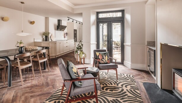 A spacious kitchen with a dining area, a fireplace, and a large window. - Springfield-Windermere (Windermere)