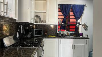 Fridge, coffee/tea maker, toaster, cookware/dishes/utensils