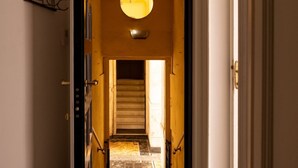 A hallway with a staircase leading to a room.