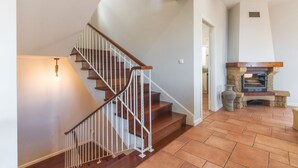 A staircase with white railings and wooden steps leading to a door. - Casa dos Namora by Atlantic Holiday (Camara de Lobos)