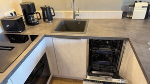 Fridge, stovetop, dishwasher, coffee/tea maker