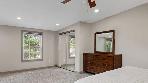 A bedroom with a large window, a wooden dresser, and a bed. - Charming 1-bedroom house in fabulous Florence Alabama (Florence)
