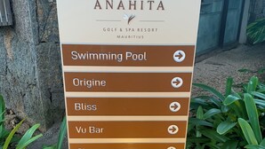 A sign for Anahita Golf & Spa Resort Mauritius listing amenities such as Swimming Pool, Origine, Bliss, Vu Bar, Signature, Beach, and Boat House. - Apartment at Anahita 5*Resort : golf & access to Ile aux Cerfs exclusive beach 4 (Beau Champ)