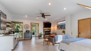A modern living space with a kitchen, dining area, and a bedroom. - King Bed | Boho Charm | 2 minutes to Downtown (Eureka Springs)