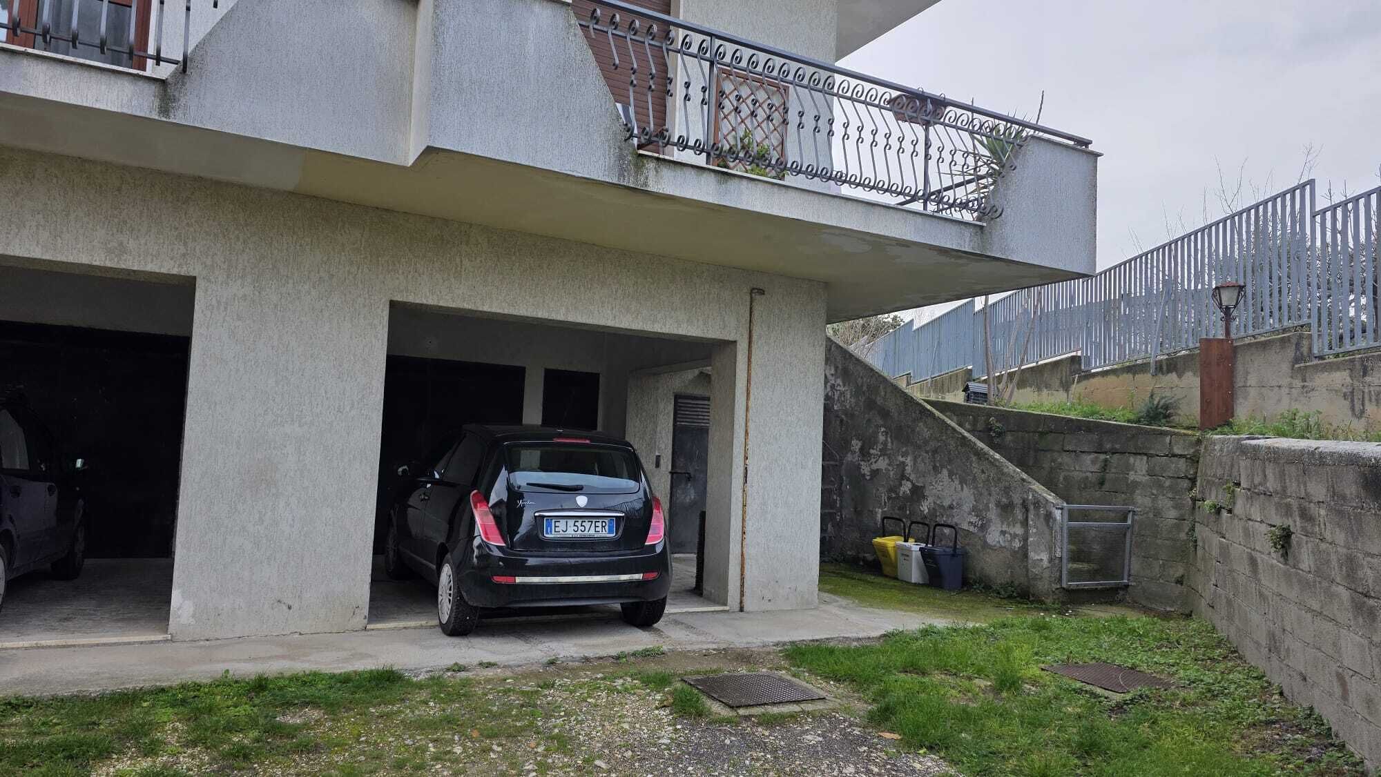 A modern building with a car parked in a garage.