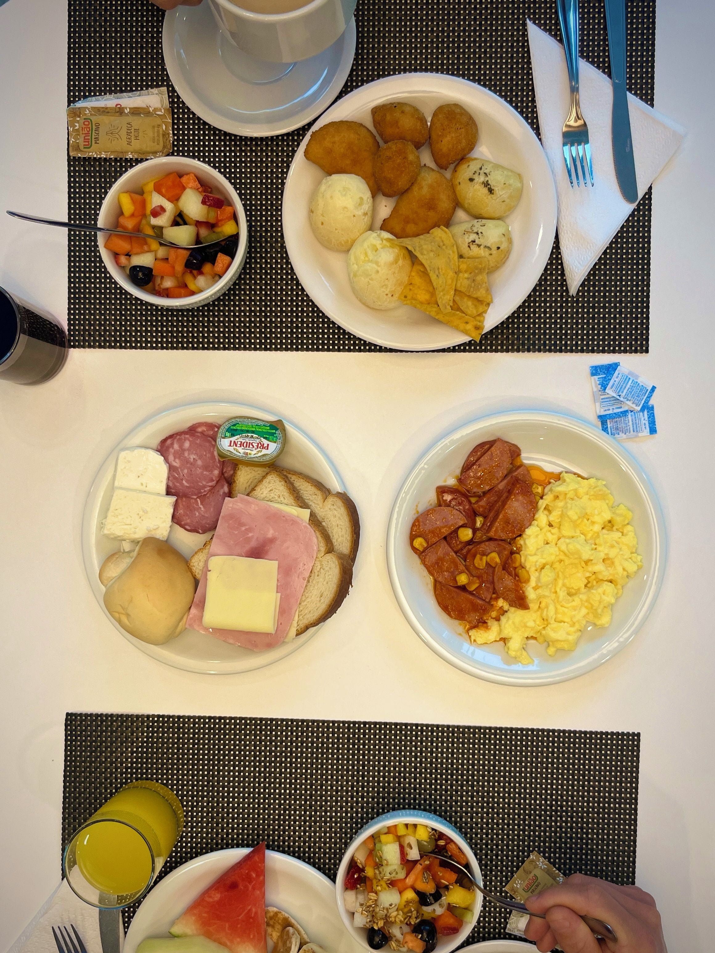A breakfast buffet with various food items and condiments.