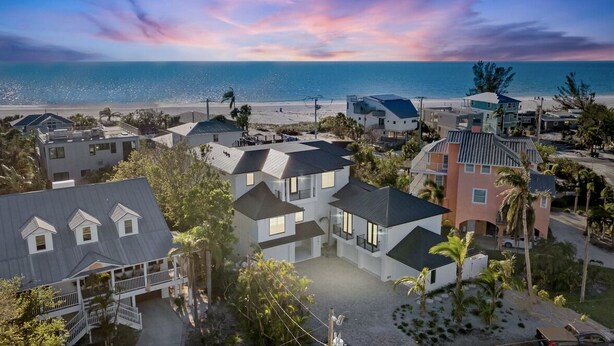 A coastal residential area with modern houses, a beach, and a clear sky. - Lazy River! Mini Golf! Sleeps 16 Anna Maria Island - Nautical Situation (Anna Maria)