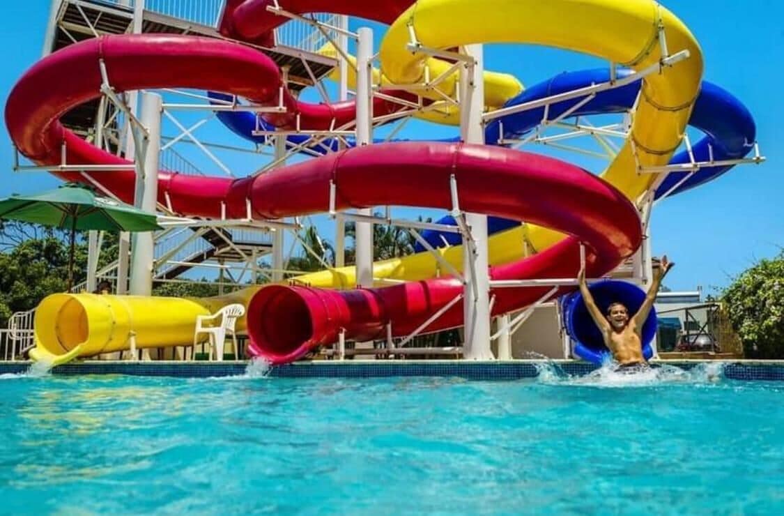 A water park with multiple slides in red, yellow, and blue colors.