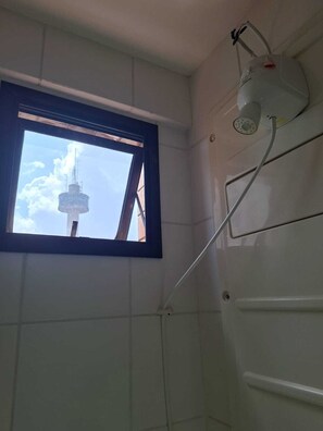 Shower, hair dryer, towels, toilet paper