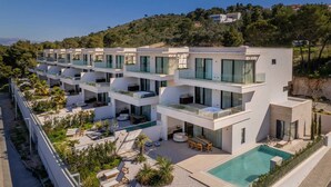 A modern multi-story hotel with outdoor swimming pools, terraces, and lush landscaping. - Luxury Villa Lunea with Pool I (Trogir)
