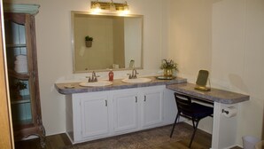A bathroom with two sinks, a large mirror, and a desk with a chair. - Relaxing Country Getaway – Pet Friendly, Close to Greenville & Spartanburg (Greer)