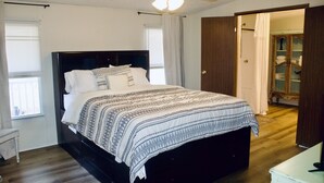 A bedroom with a large bed, a ceiling fan, and a wardrobe. - Relaxing Country Getaway – Pet Friendly, Close to Greenville & Spartanburg (Greer)