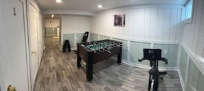 A room with a foosball table, exercise equipment, and a door with a number. - Beautiful apt, serene design in Bay City-Perfect for a getaway,close to downtown (Bay City)