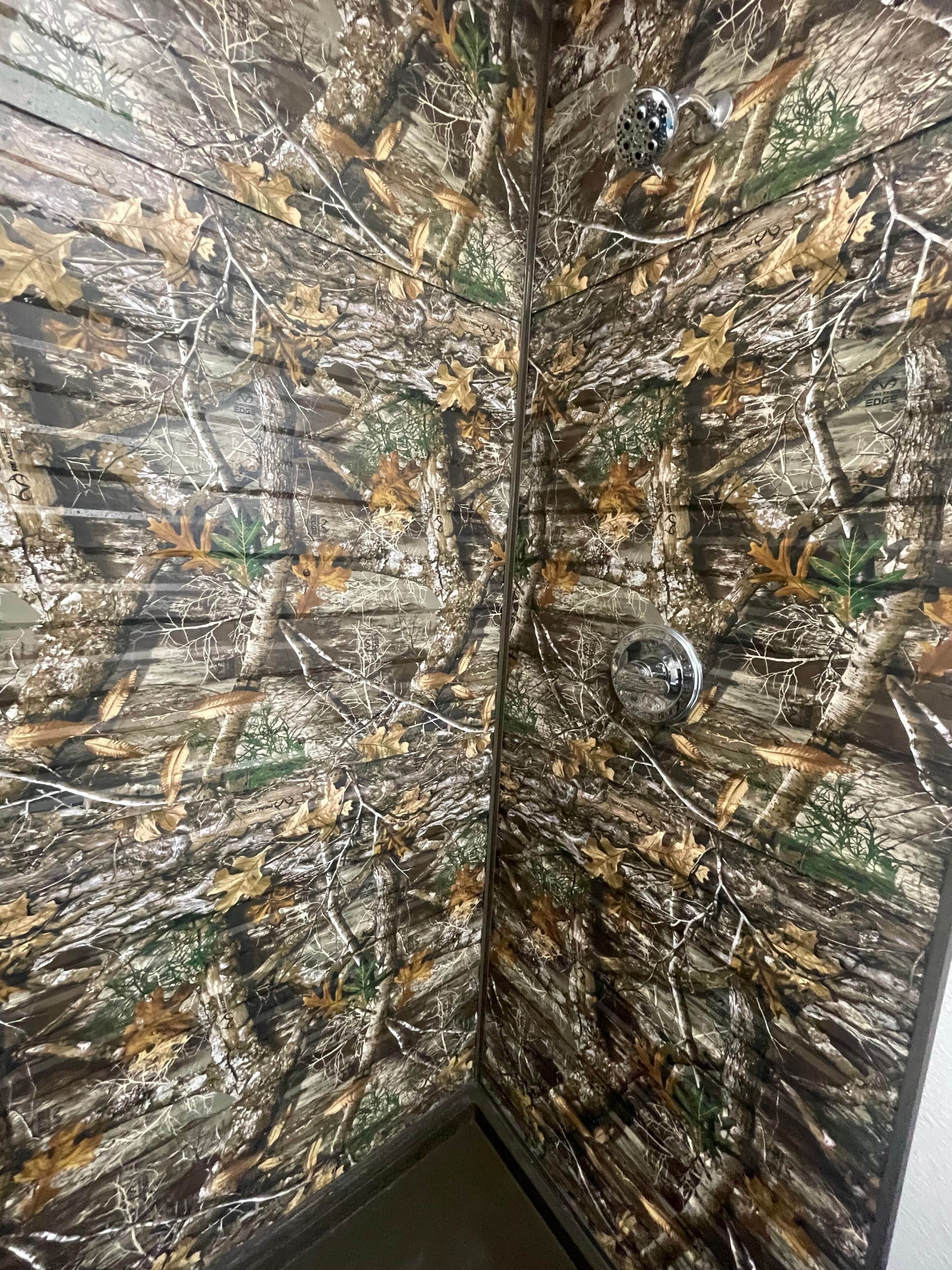 Une salle de bain avec un motif de camouflage sur le mur.