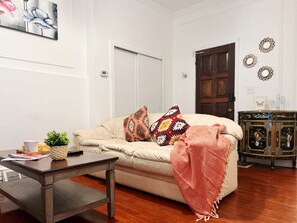 A living room with a sofa, coffee table, and decorative pillows.