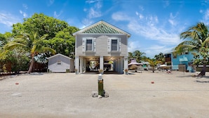 A two-story building with a gabled roof and a covered entrance. - Big Pine Turtle House (Big Pine Key)
