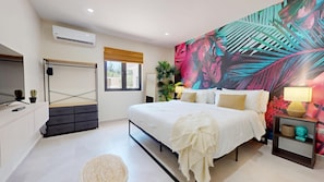 A modern bedroom with a bed, bedside tables, a desk, and a large window. - Palm Beach Hideaway #6: Poolfront 2BR/2BA, Rooftop, Near Palm Beach (Noord)