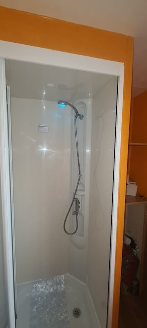 Shower, hair dryer, soap, toilet paper