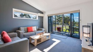 TV, books - "Orion" 3BR Water Views Apartment Main Street of Huskisson by Nautilus Apartments Jervis Bay (Huskisson)