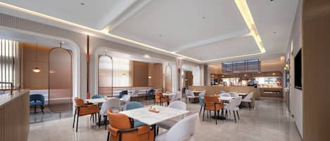 A modern restaurant with a clean, minimalist interior, featuring a mix of seating arrangements and a central dining area.