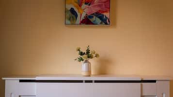 A white radiator with a vase of flowers on top.