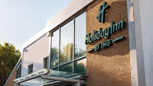 A Holiday Inn by IHG building with a modern design, large windows, and a brick facade. - Holiday Inn Newcastle South by IHG (East Boldon)