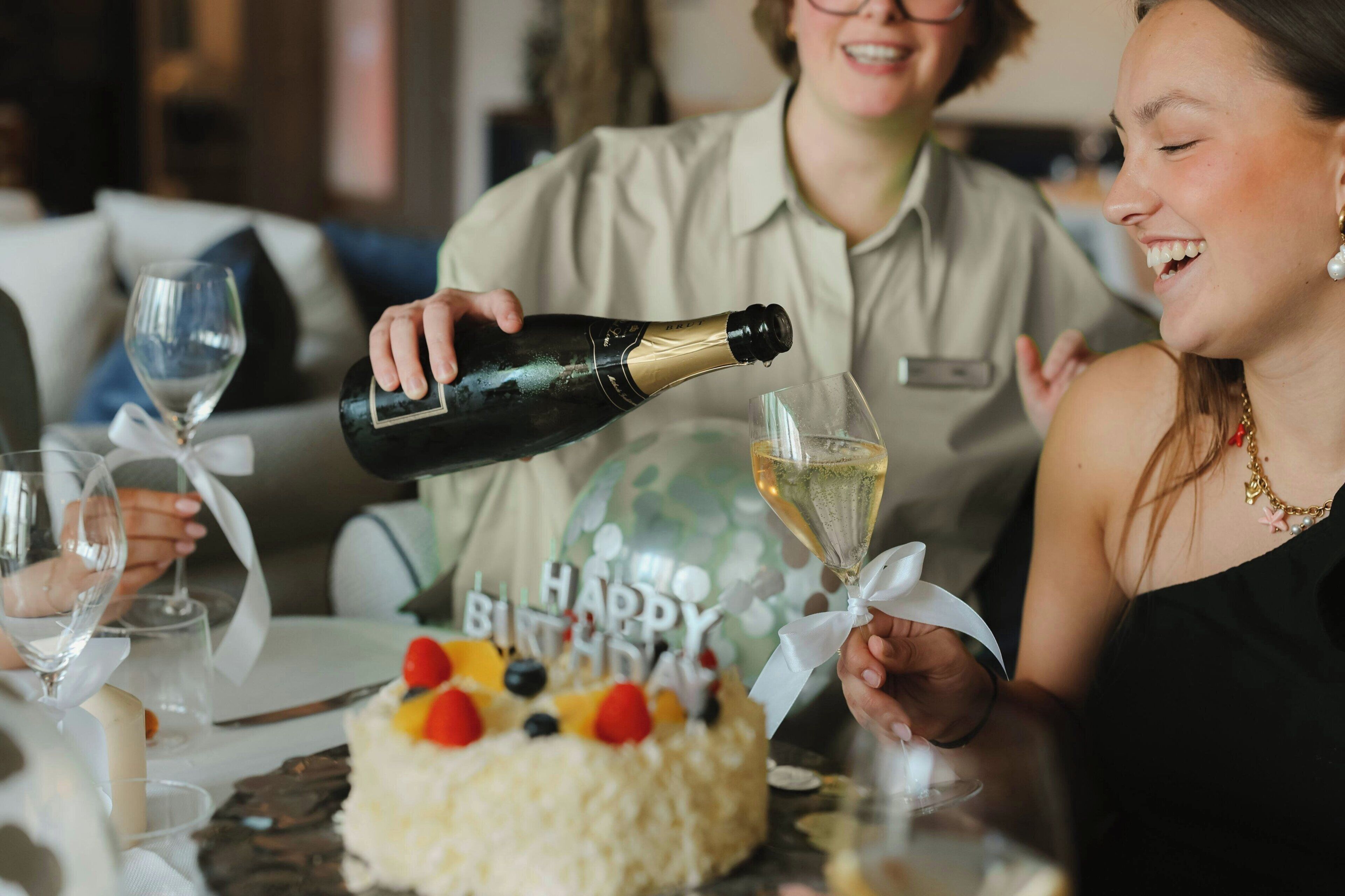 A birthday celebration with a cake and champagne.