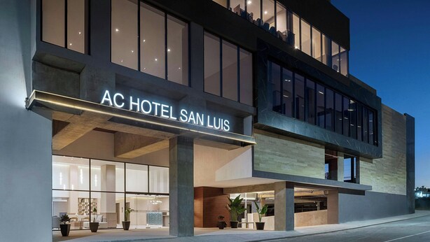 The exterior of AC Hotel San Luis with a modern design, large windows, and a prominent entrance. - AC Hotel By Marriott San Luis Potosi (San Luis Potosi)