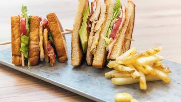 A plate with two sandwiches and a side of French fries.
