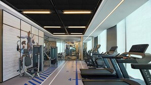 A gym with treadmills, weight machines, and a mirrored wall. - Four Points By Sheraton Shenzhen Bay (Shenzhen)