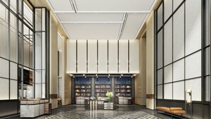 A spacious lobby with a central seating area, a reception desk, and a large shelving unit displaying various items. - Four Points By Sheraton Wuhan Hankou (Wuhan)