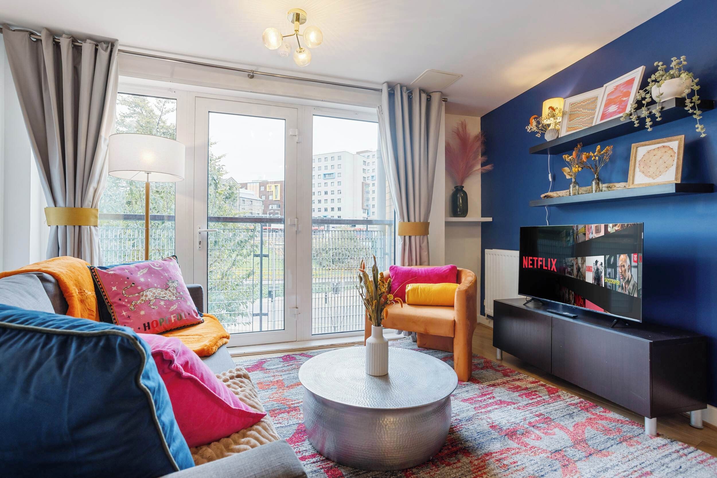 A modern living room with a sofa, coffee table, and TV.