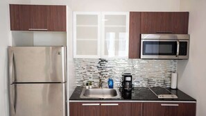 Microwave, stovetop, cookware/dishes/utensils, dining tables
