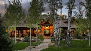 A log cabin with a stone pathway leading to the entrance, surrounded by birch trees. - Abode at Teton Game, sweeping estate with 3 cabins (Wilson)