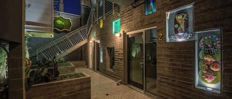A modern interior with a staircase, wooden walls, and glass doors.
