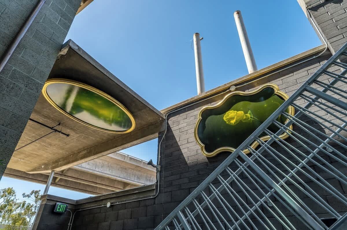 A staircase with a metal railing and a green decorative element.