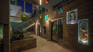 A modern interior with a staircase, wooden walls, and glass doors.