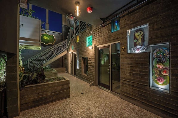 A modern interior with a staircase, wooden walls, and glass doors.