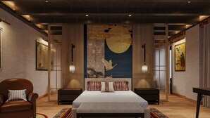 A spacious bedroom with a large bed, a wooden floor, and a night sky mural on the wall.