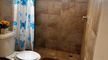 Een douche, handdoeken, toiletpapier