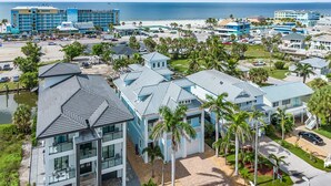 A coastal hotel complex with multiple buildings, a beach view, and a parking area. - 571 Seabatical: Canal Front With Pool! (Fort Myers Beach)