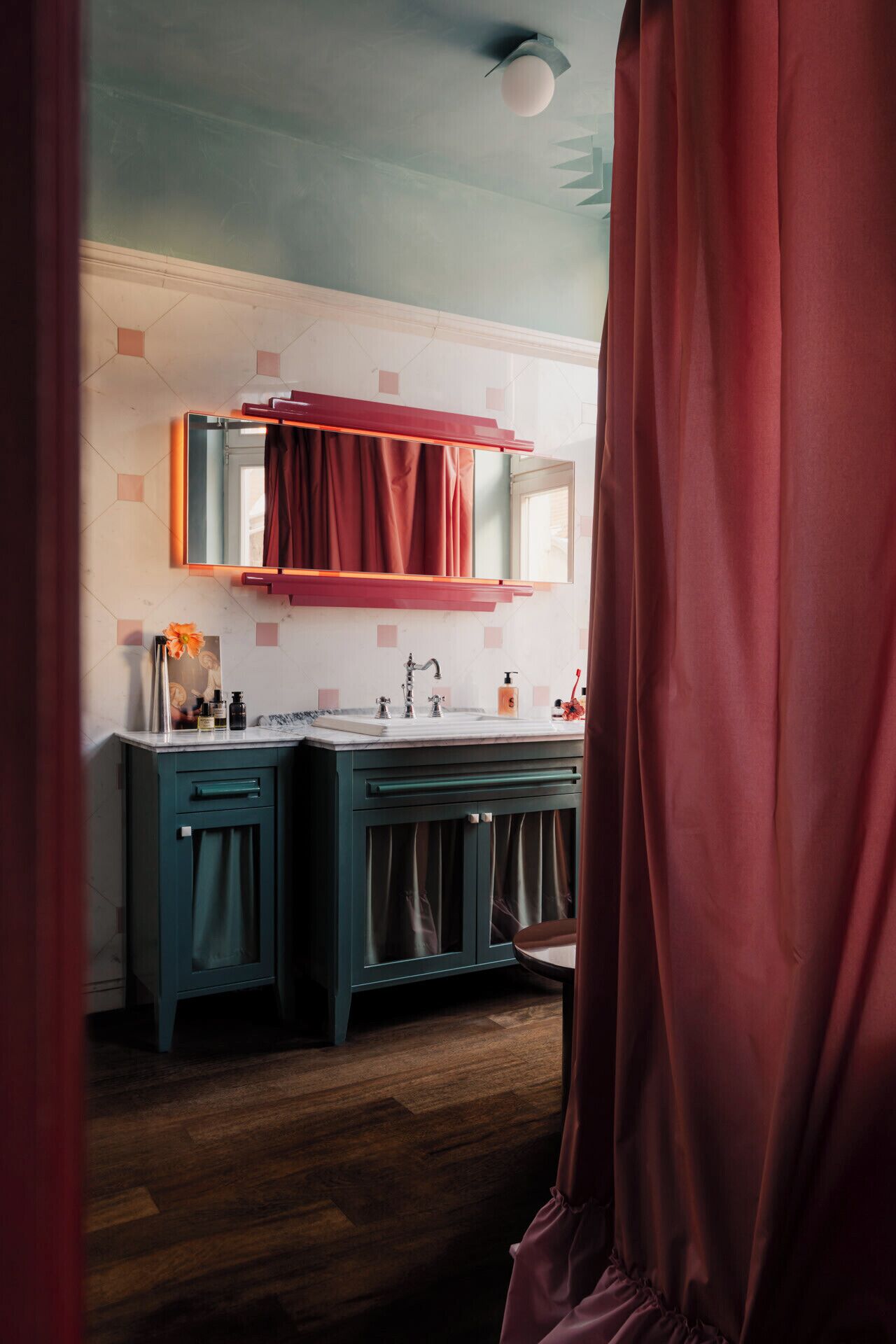 A bathroom with a double sink, dark cabinets, and a mirror above the sink.