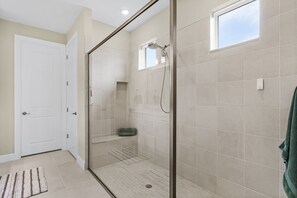 A modern bathroom with a glass-enclosed shower, a small window, and a towel rack. - Charming, Comfort and Relaxation Await! - Casa Bella - Roelens (Cape Coral)