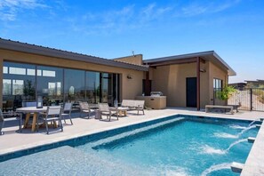 A modern house with a swimming pool, outdoor furniture, and large windows. - Paradise Canyon-Pool w/ Mountain Views-Estate 1&2 (Fort Mcdowell)